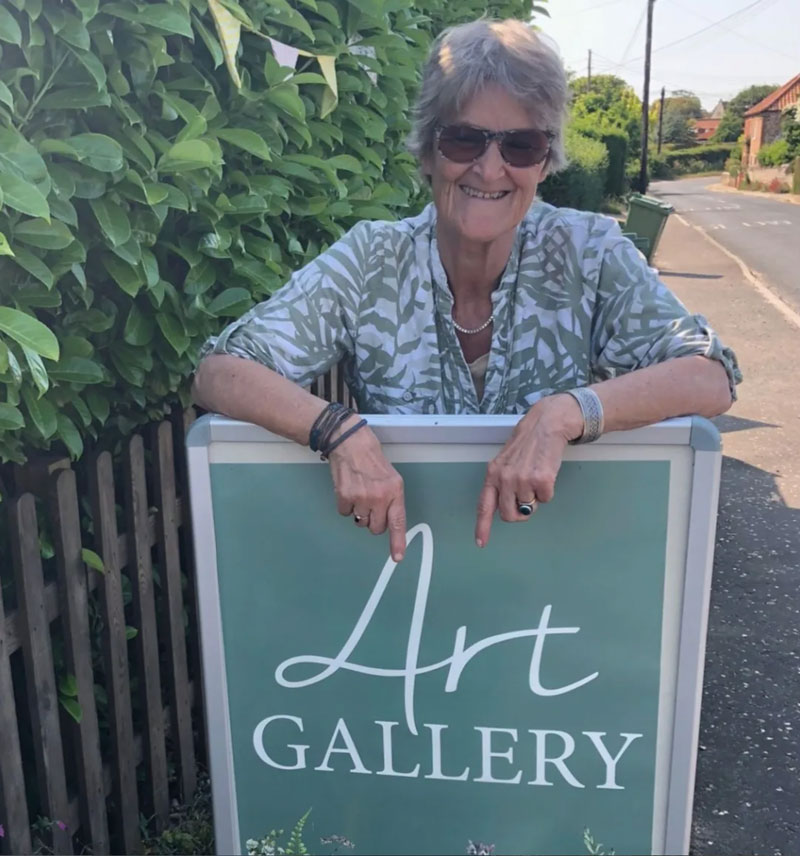 Hanneke with The Garage Studio Art Gallery sign
